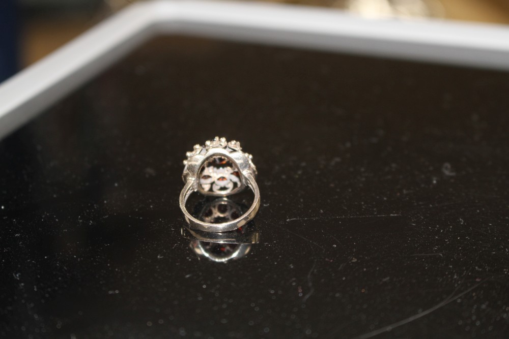 A 14k yellow metal and nine stone garnet cluster dress ring, size O, gross weight 5.6 grams.